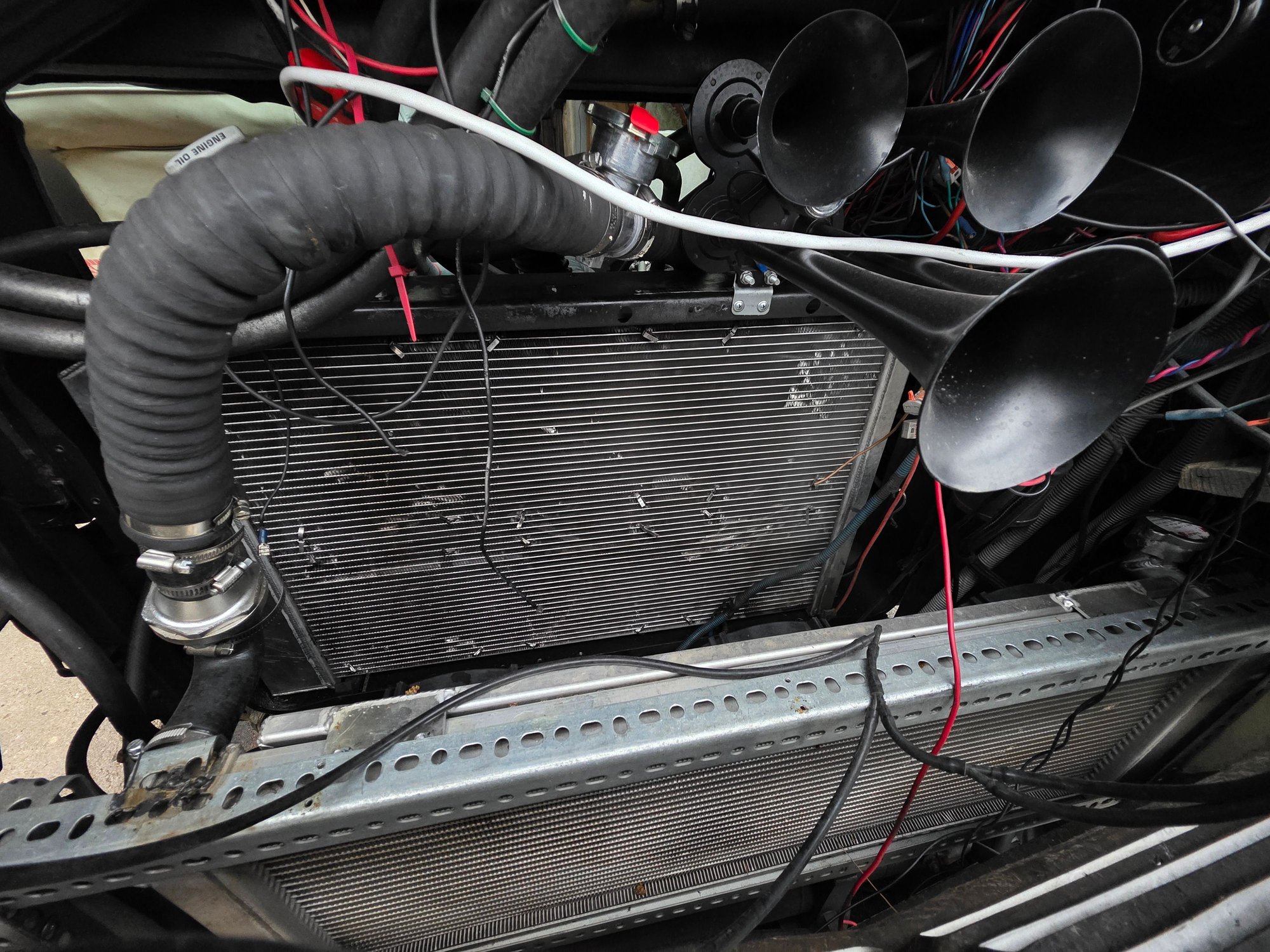the rear radiator is 5 row all aluminum and is run as the aux at 180f. the front radiator is the primary and opens at 160. it is capped at 24psi.