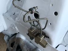 This proportioning valve is the very first thing I bolted back onto the car. 9,999 parts to go!