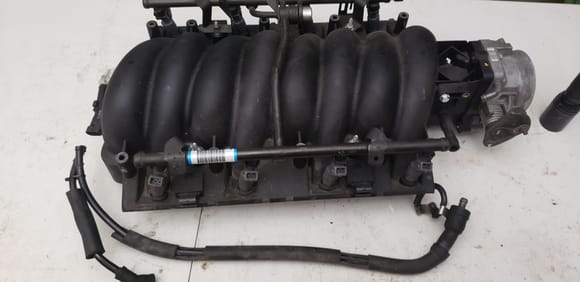 Notice the metal PCV valve thats connected to the line? I would install my catch can on this line to the intake manifold.