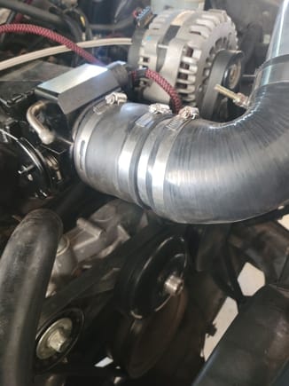 I had to put a little extension piece here, the 90 was to short and causing the piping to hit the alternator so i cut a piece out of my old intake and added it in