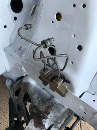 This proportioning valve is the very first thing I bolted back onto the car. 9,999 parts to go!