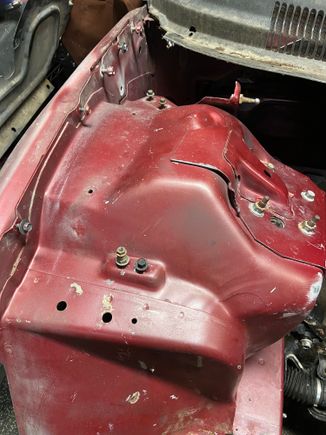 Welded in holes in front of shock tower along with some on opposite side.