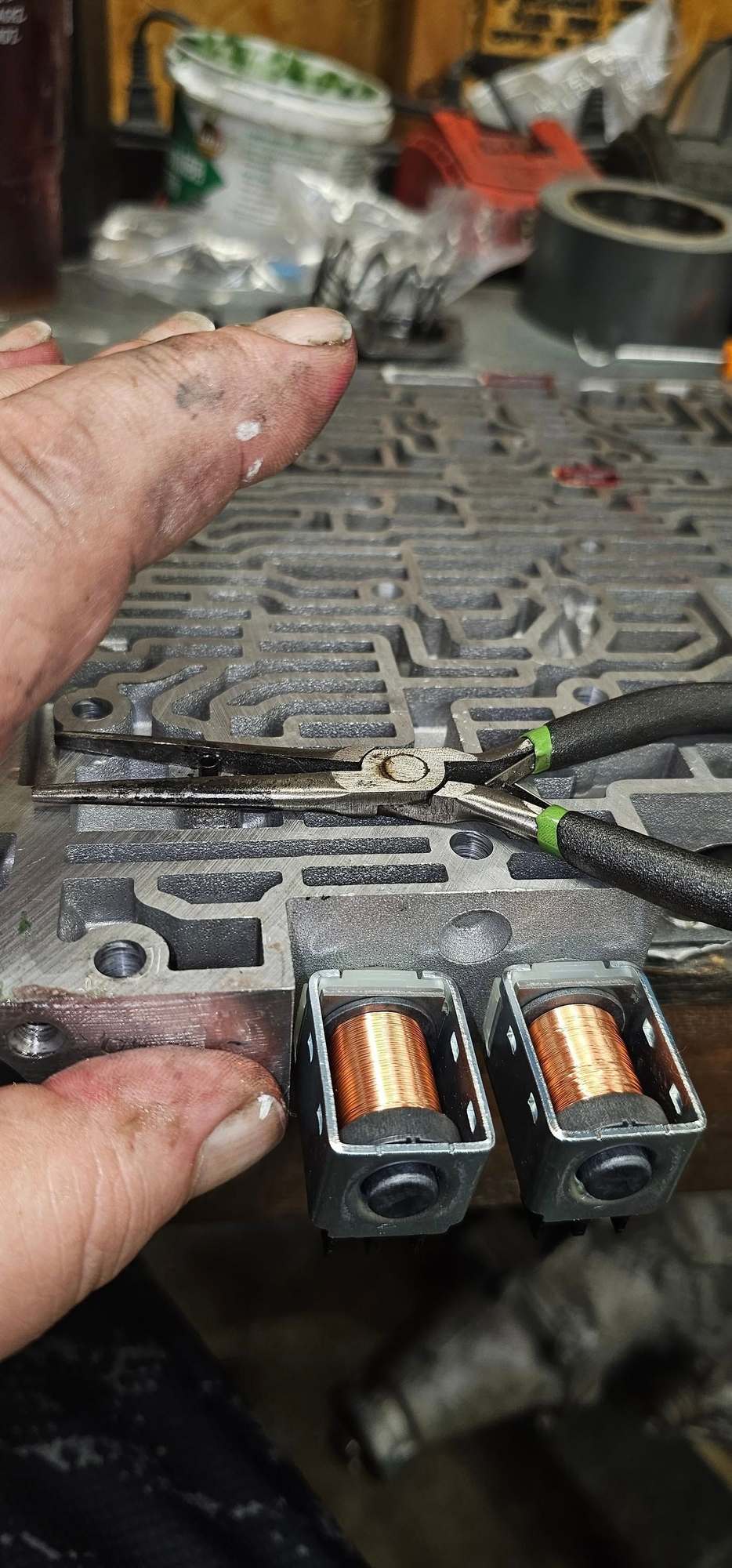 Use a pocket screw driver and push roll pin from botom enough to eb able to grab it from vb top. place thumb over hole and remove roll pin. Remove old bore plug and push inner rping and valve back into bore. If you have one use a pipe brush brass to quicky debur bore on drill or drimel . blow out hole. 