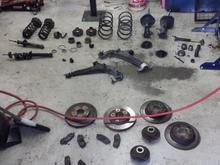 These are all of the factory components that were removed.
Literally EVERYTHING. 

-Entire Suspension Upgrade:

-Tokico Illumina Adjustable struts.
-Tein H-Tech drop springs.
-Timken wheel hub (x4)
-Timken wheel bearing (x4)
-PowerStop ceramic brakes.
-PowerStop Drilled/Slotted rotors.
-OEM stabilizer bar (x2)
-OEM control arm (x2)
-MOOG ball joint (x2)
-OEM inner/outer tie rod (x2)
-KYB strut mounts (x4)
-OEM bumpstops.
-OEM motor mount (x4)
-Megan front strut bar.
-Energy Suspension Polyurethane Sub-frame kit
-Energy Suspension Polyurethane tie rod kit
-Energy Suspension Polyurethane control arm kit
-20mm rear wheel spacers

(Probably more that I'm forgetting)