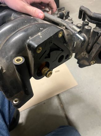 Where the piece was connected. It had springs inside the white plastic piece that stuck out, they fell while I was taking the upper intake manifold off & I do not think I found all of them (I found 2, one large & one small)