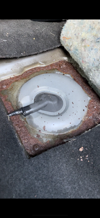 Under left rear seat, here is the service hole cover.
