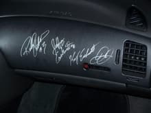 Dash piece signed by Richard Childres, Jeffrey Earnhardt, Kerry Earnhardt, and Dale Jr.
