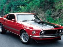 My first love was a younger lady....look at those hips and what a shake..shaker hood that is.  candy apple red, black dayglo stripes, flat black hood stripes, 351-4bb with stick shift...i still miss her 21 years later
