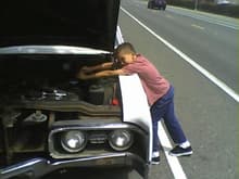 My youngest son loosenin' a valve cover on my Delta 88.