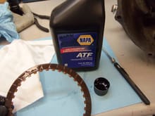 Applying ATF to the clutch plates prior to reassembly.