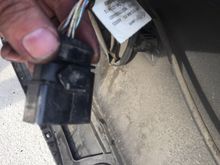 Connector disconnected from rear cover...you can see the clip...slide up to remove