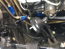 You can see the output tube coming from the grommet in the fender and connecting directly to the tube from the hood. Meanwhile the original pump connector now connects to the new harness to the tank mounted pump. I zip tied the connector out of the way so it won’t rub or rattle.