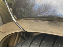 Ding on passenger rear wheel opening.