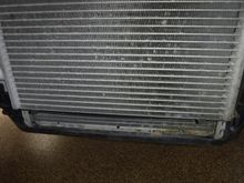 Lower part of left radiator visible below the AC condenser.