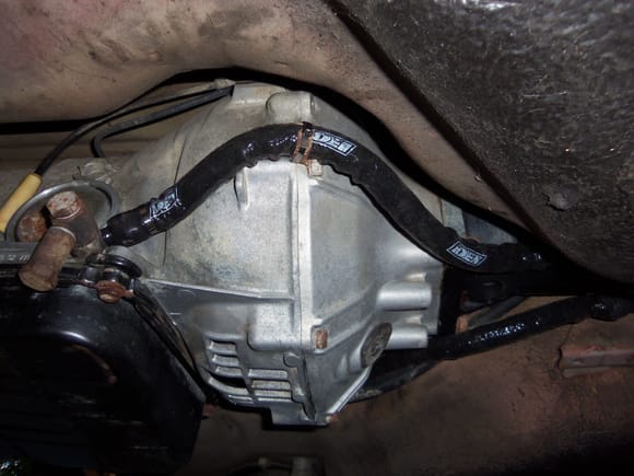 Passenger's side line at transmission. Note fill port, and note the stainless steel zip tie around the flimsy factory locating clamp on the torque converter housing.