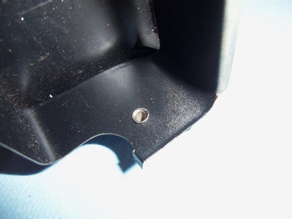 Back side of rivet holding plastic lid to ash tray frame.