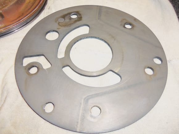 Separator plate has no burrs. The discoloration did not clean off with solvent and cannot be felt with a finger tip. I did NOT use scotchbrite on this plate. This side of the plate faces the pump gears.
