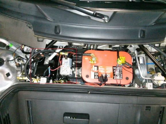 Compressor is to the left of the battery and AirLift control module to the left of that