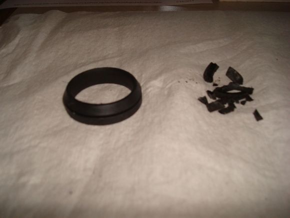 The 2 Shifter shift tube bushings.  The broken one is what fell out of the rubber boot.  I always wondered what caused my shifter to feel sloppy