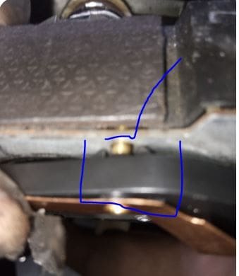 It doesn't look like the two clips can fit in the hole with the gold plug? But the prior horn pad was flat to the metal surface.