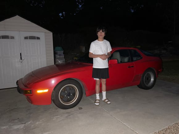 My son and his new used non running car.  