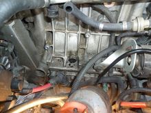 You can see the drain hole into the block from the bottom of the PCV oil trap was completely had-packed clogged.  I very carefully cleaned it out keeping as much of the stuff out of the engine as possible and the used a cloths hanger wire to "ream" it out the rest of the way.  I used a minimum of solvent to help the cleaning.