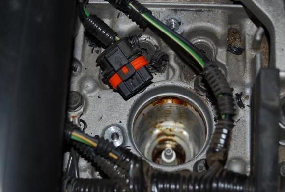 Photo from #5 Misfire.  A little oil srayed out.  Note the broken pieces of shielding.  Vaccum that stuff out before pulling the plug.  The ignition coil replacement was the fix, but the oil can't be forgotten.  A project for another day  I am sure.