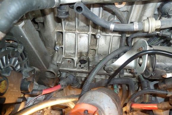 You can see the drain hole into the block from the bottom of the PCV oil trap was completely had-packed clogged.  I very carefully cleaned it out keeping as much of the stuff out of the engine as possible and the used a cloths hanger wire to "ream" it out the rest of the way.  I used a minimum of solvent to help the cleaning.