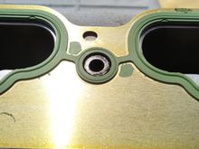 Lining up 2 Manifold Isolator bolts around the gasket ridge holds it in place for installation