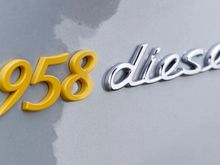 Yellow 958 Chrome diesel badge on silver background