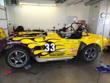 Factory Five Roadster racercar in yellow with black flames (Shelby Cobra replica made by Factory Five).