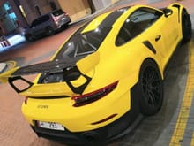 Yellow Porsche 911 GT2 RS at the Pearl Harbor in Doha, Qatar. 