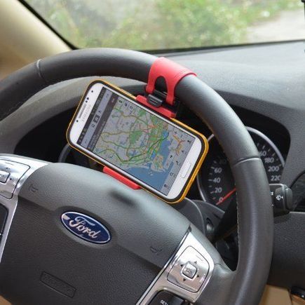 the red iphone holder perfectly compliments the black alcantara steering wheel with red stitching found on the 2015 Porsche Cayenne GTS