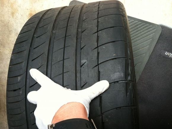 Left rear tire w/ gash and nail puncture. Replacing this tire w/ brand new Mich PS2.