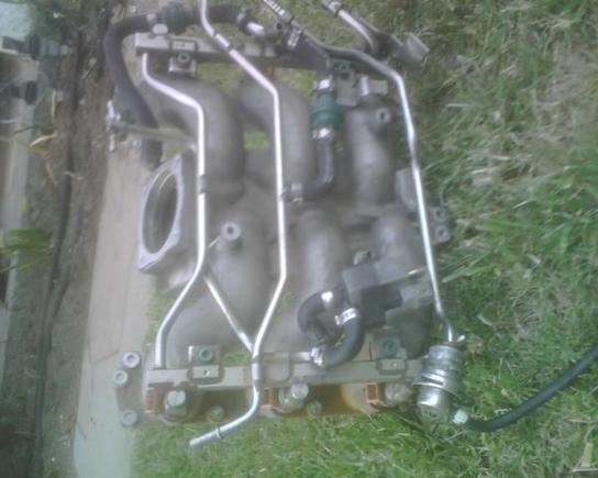 Intake manifold and fuel rail removed to get to gushing aux. water pump.