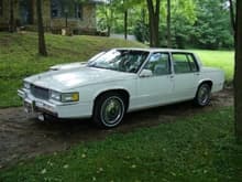 Up at my parents house right after I changed the rims from steel rims w/ fake wire rim hubcaps to the chrome rims you see here. Alongside it is my dad's last Cadillac, a '90 Fleetwood.