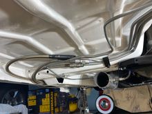 Another view of stainless and hard fuel lines under car.