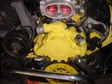 Yellow painted manifold and water pump, yellow wires, ignition coil, and strut stabilizer.