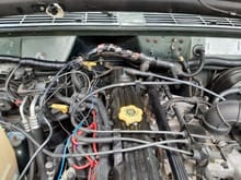 Here you can see where I soldered and added heatshrink tubing to the extention. You can also see I am pulling the windshield washer hose out of the main wiring harness. The rubber was in decent shape, but I do not understand why Chrystler deaigned it like this.