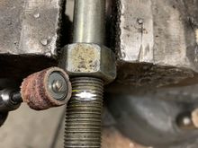 Use a dremel to create a flat spot where you want the hole.