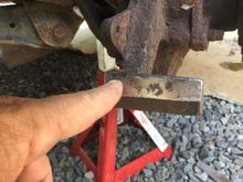 Worn divit on bottom of knuckle. This is what the helpful members are referring to. With deep grooves,the proven fix being to weld the depressed area. Mine is not bad,so I am going to file the depression and all other areas,to give the pads a smooth surface to ride on. These areas must be lubed with disc brake lube also. I also cleaned up the pads backing plates.