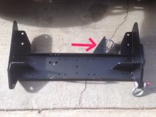 Here it is before I bolted it in. The arrow points to a steering box brace. I used a modified, heavy duty exhaust clamp to secure it. You can see most of the attach points here also. The shackle attach to an area that is 3/4" thick.