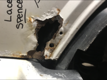 The majority of the rust, just above the bumper cap 