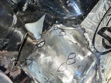 I put a light underneath the panel to find and mark pinholes to be filled after grinding down the initial stitches. 