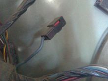 This is located on the driver side, in the rear, near the cluster of plugs for the back hatch. I presume, given the same color, this is connected to the wire under the steering wheel. 