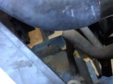Trying to get at the bent up stuff below, mounting the radiator was a bitch due to my left side being tagged and yanked back out by the original owner