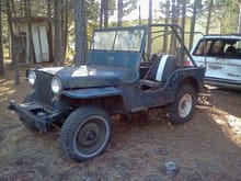 My new '48 CJ2a in it's new Idaho home.  Looks can be deceiving, the front clip is just sitting on the frame and the hood on it.  Front tires are JCPenney specials. Front and rear tires are different sizes so a new set of skinny tires will have to be found.  I placed a used 215x75r15LT next to the front 6.00x15 and it is just a tad bit wider.  I have 4 of those with about 50% tread left but I'm not sure if I want radials on it.