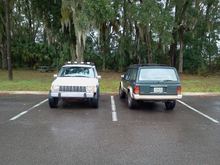 Side x side comparison: both w/ 235/75r15s. White Jeep 15x8 Pacer D window steel wheels w/ 4" bs, Green Jeep w/ OEM 15x7 wheels 5" bs.