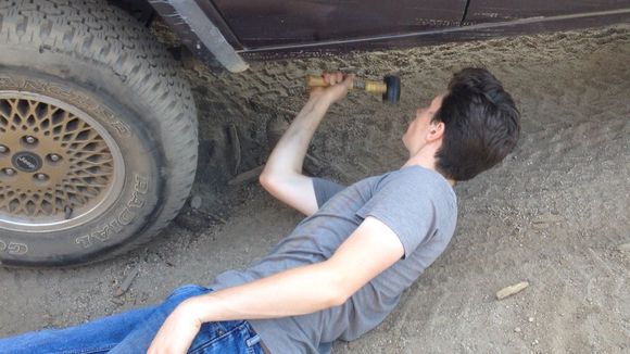 Fixing my muffler that slide off the cat with a rubber mallet Buck Rock Jeep Trail next to Big Meadows Campground in Kings Canyon section of Sequoia Nat Park.