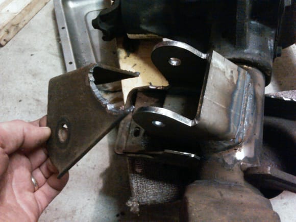 New lower control arm mounts compared to the stock sheet metal pieces I cut off.